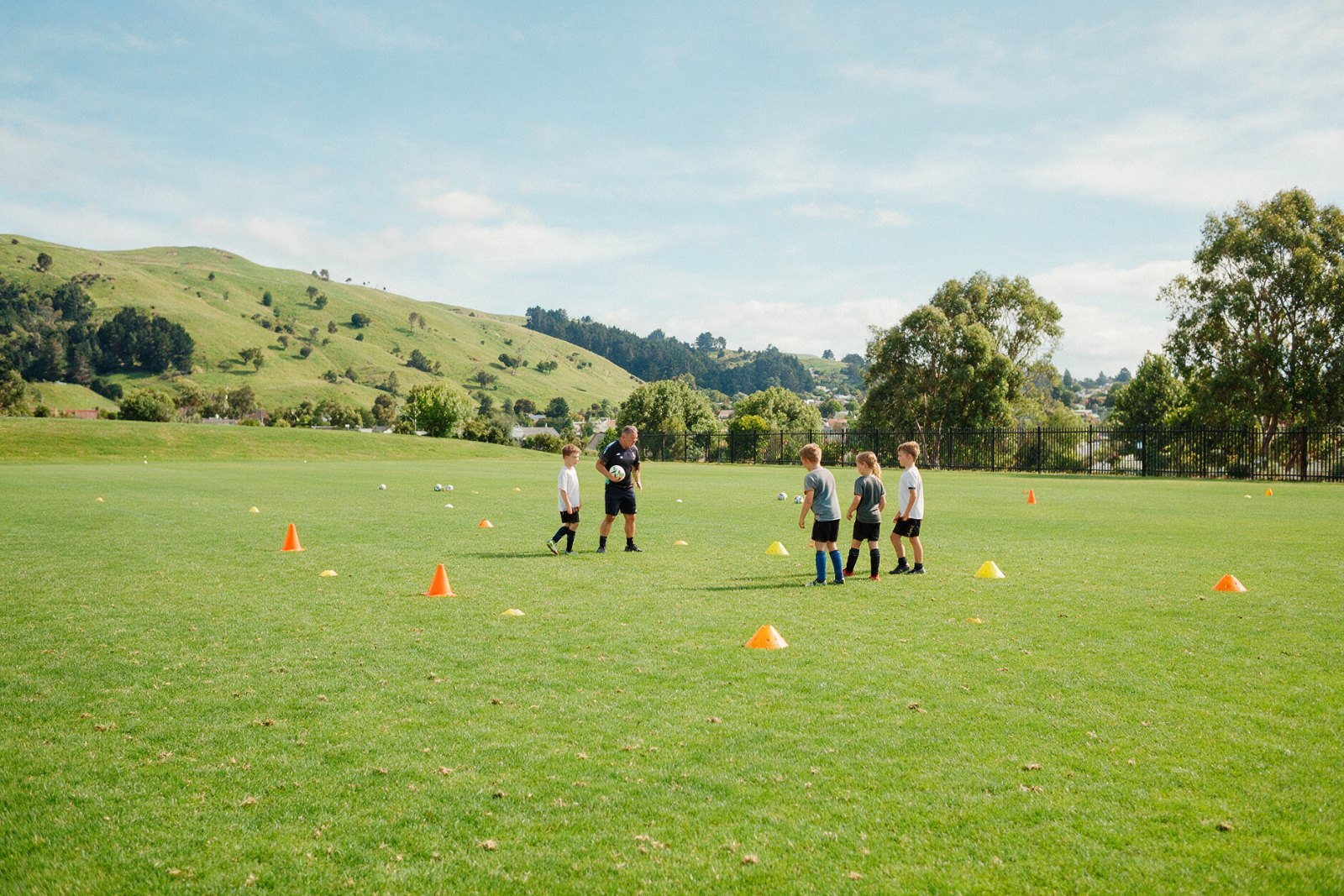 Young footballers training on a sunny pitch